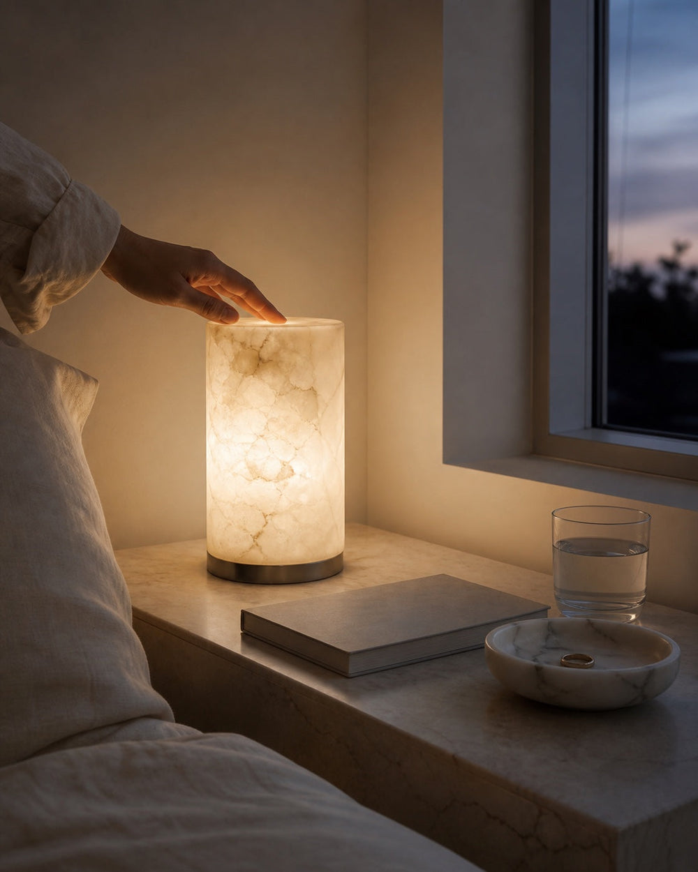 Hand activating a mineral light during an evening natural stone energy ritual