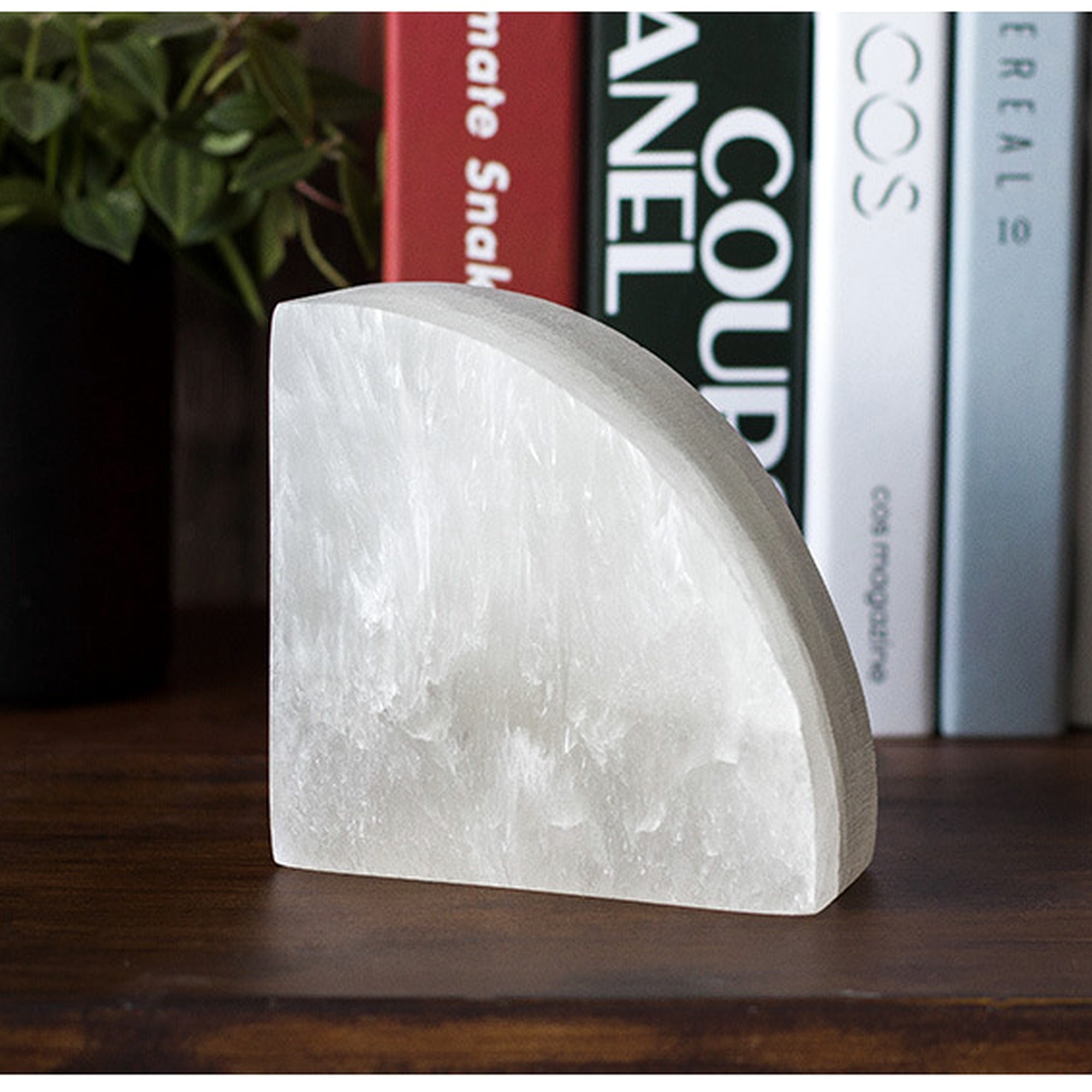 Selenite arc bookend bringing nature energy into a feng shui-inspired shelf