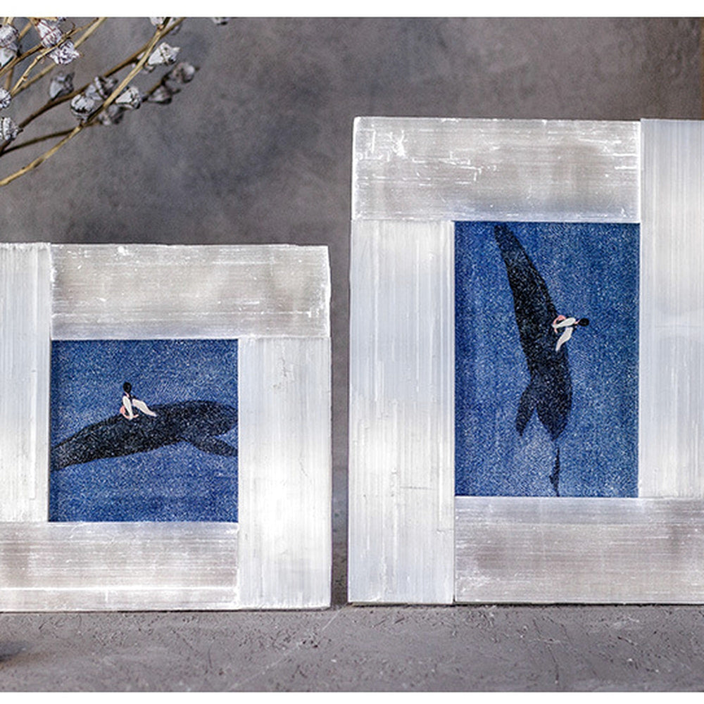 Two Selenite Mineral Photo Frames in minimal style with blue artwork against a grey wall