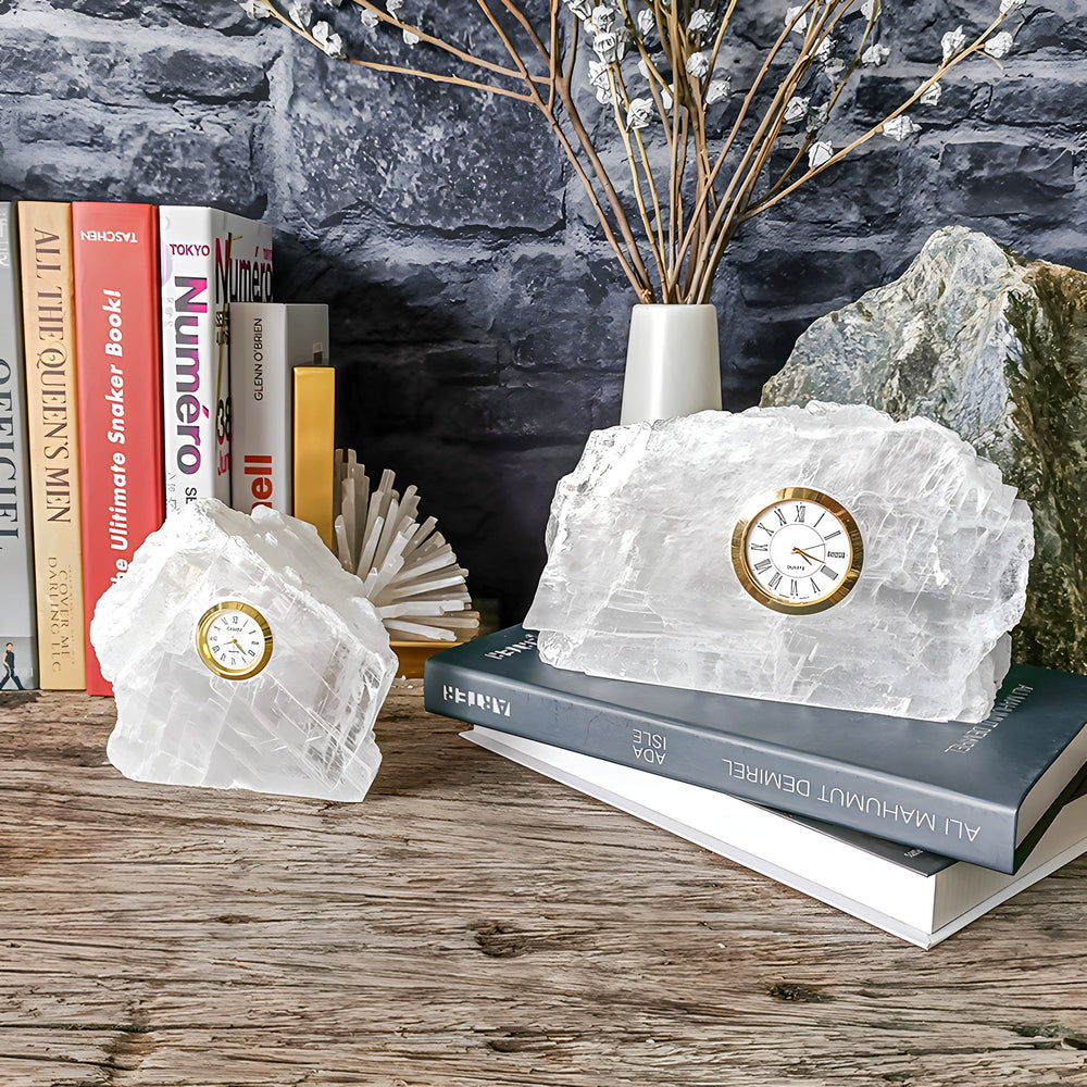 Two Selenite Mineral Table Clocks styled with books and natural stone on a wooden shelf