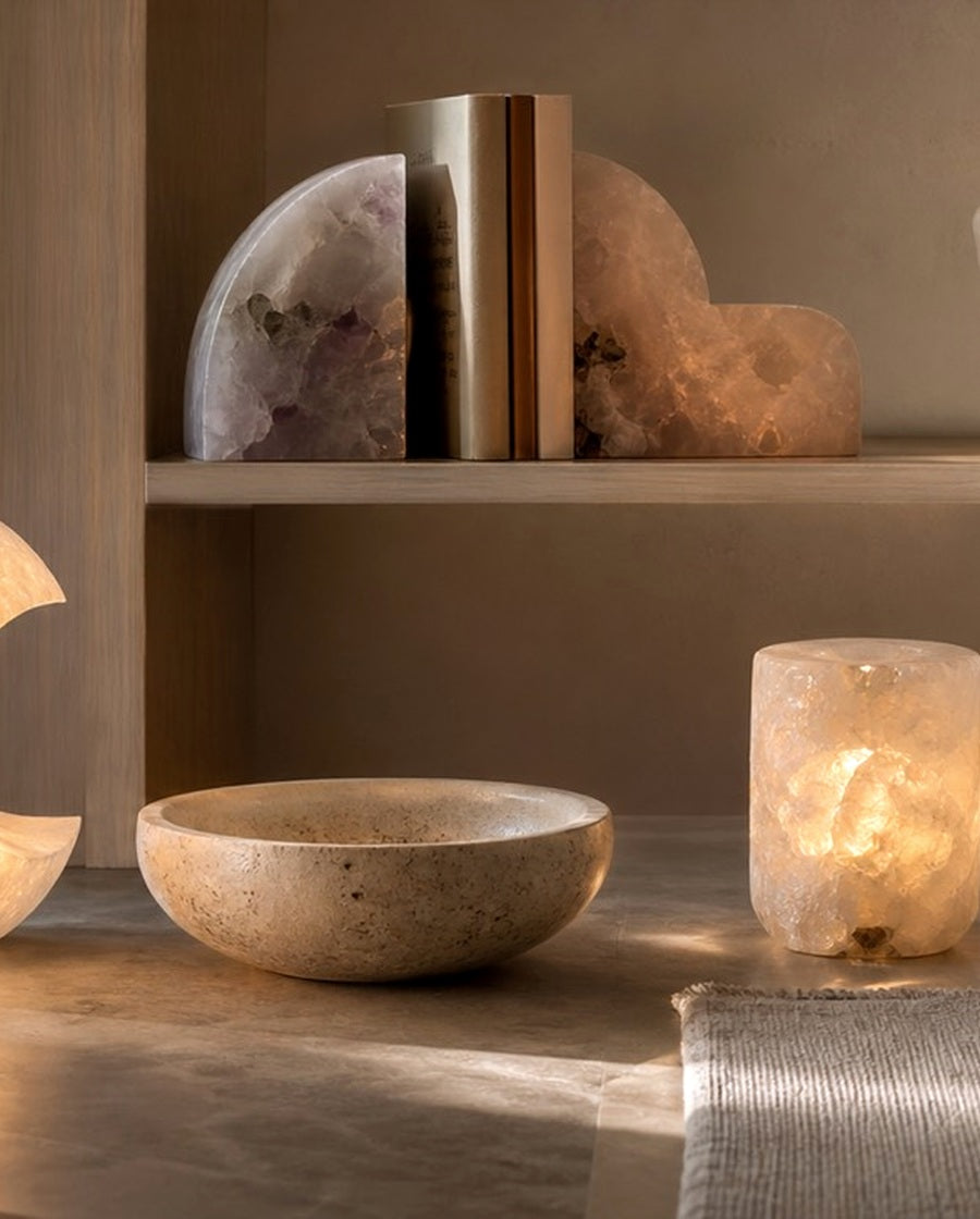 Warm mineral light and quiet stone objects in an architectural niche