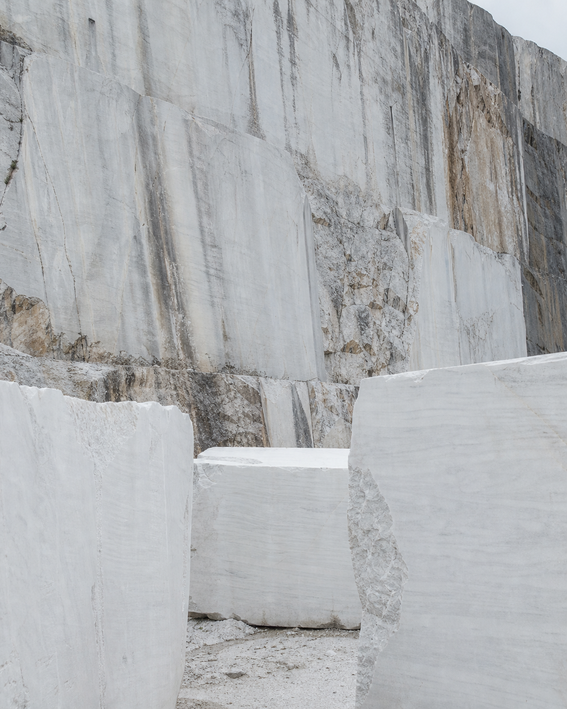 Pale marble blocks and a natural stone quarry face